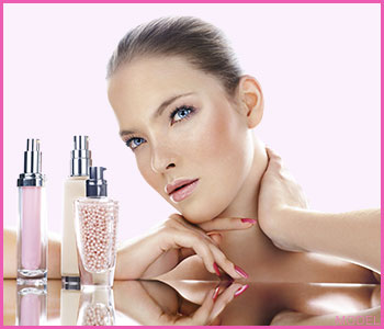 Woman posing next to skincare products