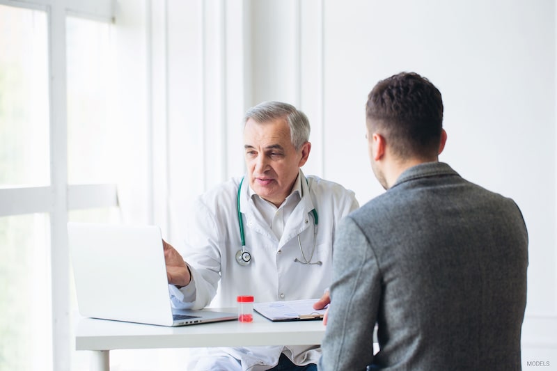 A man consults with a doctor at his office.