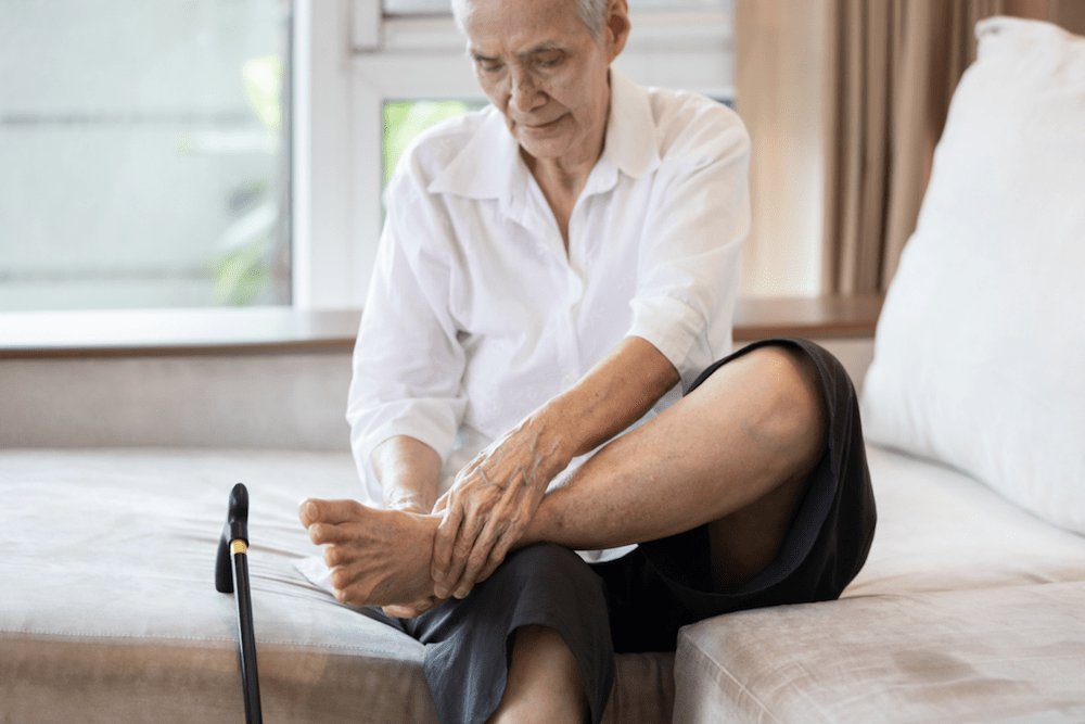 Man rubbing the bottom of his foot.